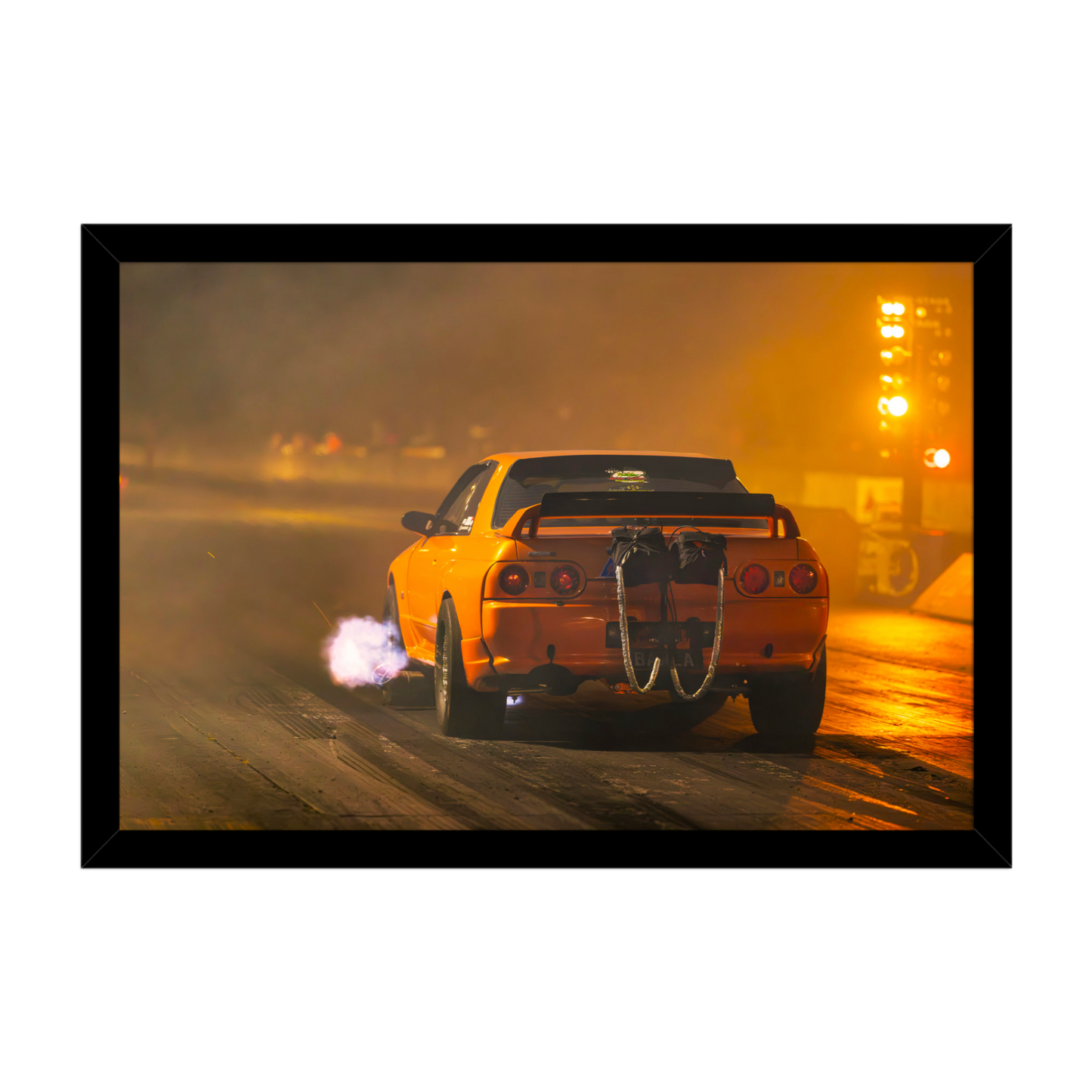 Nissan Skyline R32 drag racing at night with exhaust flame and rear parachutes