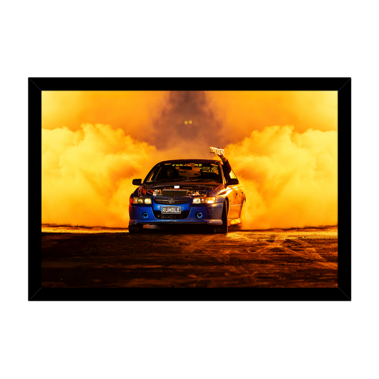 Holden burnout car driving through dramatic orange tyre smoke
